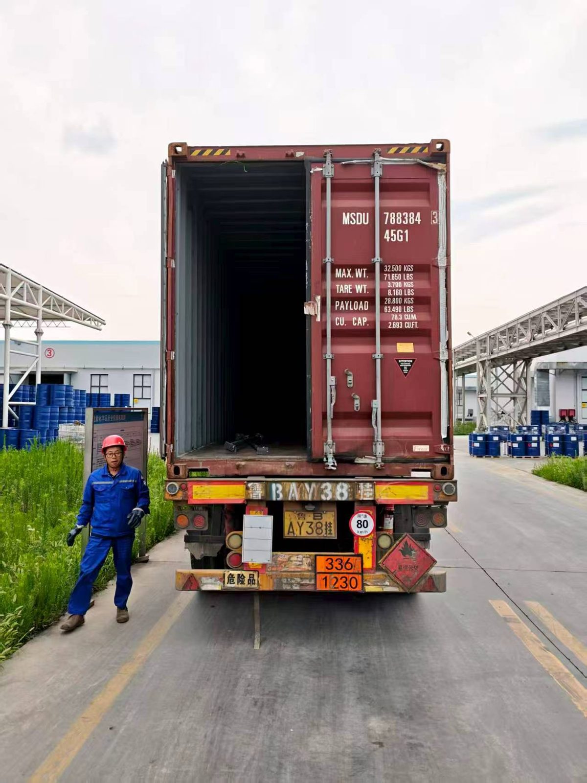 Chemical drums being loaded into shipping container at VASTEC Chemical warehouse