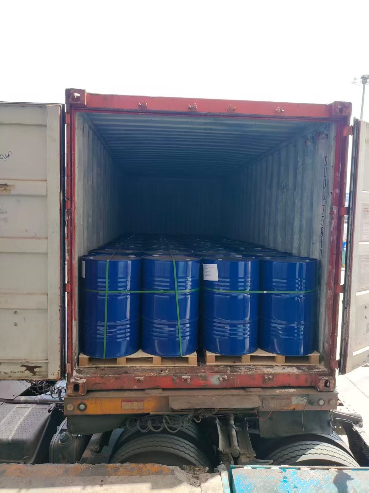 VASTEC Chemical warehouse with rows of 200L blue chemical drums - industrial chemical storage facility