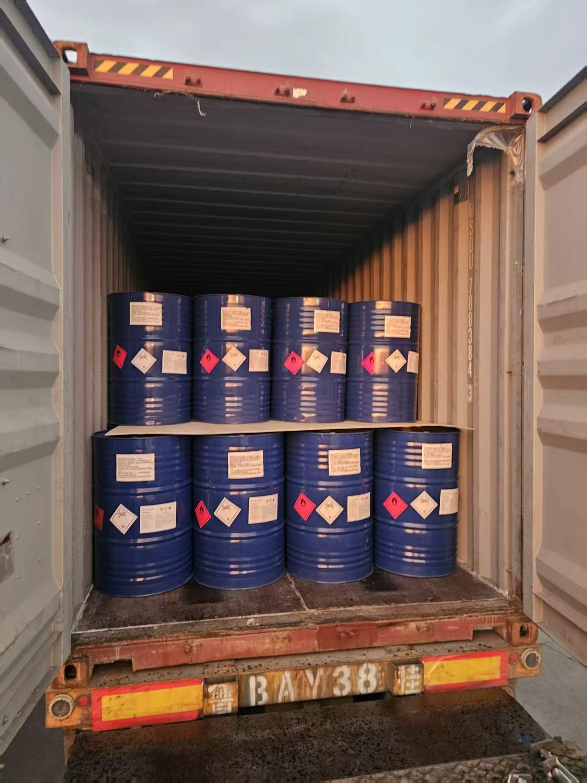 200L blue chemical steel drums stacked in shipping container - VASTEC Chemical export logistics
